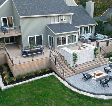 Large Outdoor living space with a multi-level wrap-around deck with outdoor kitchen and fire place