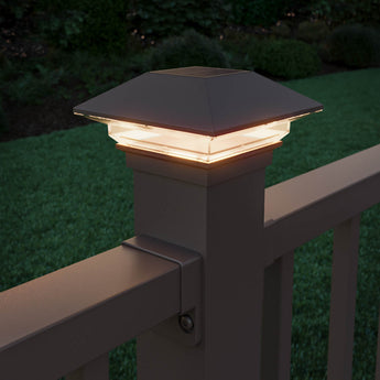 Lifestyle Close-up of Deckorators Classic Solar Post Cap Lit Up in Weathered Brown #color_weathered-brown