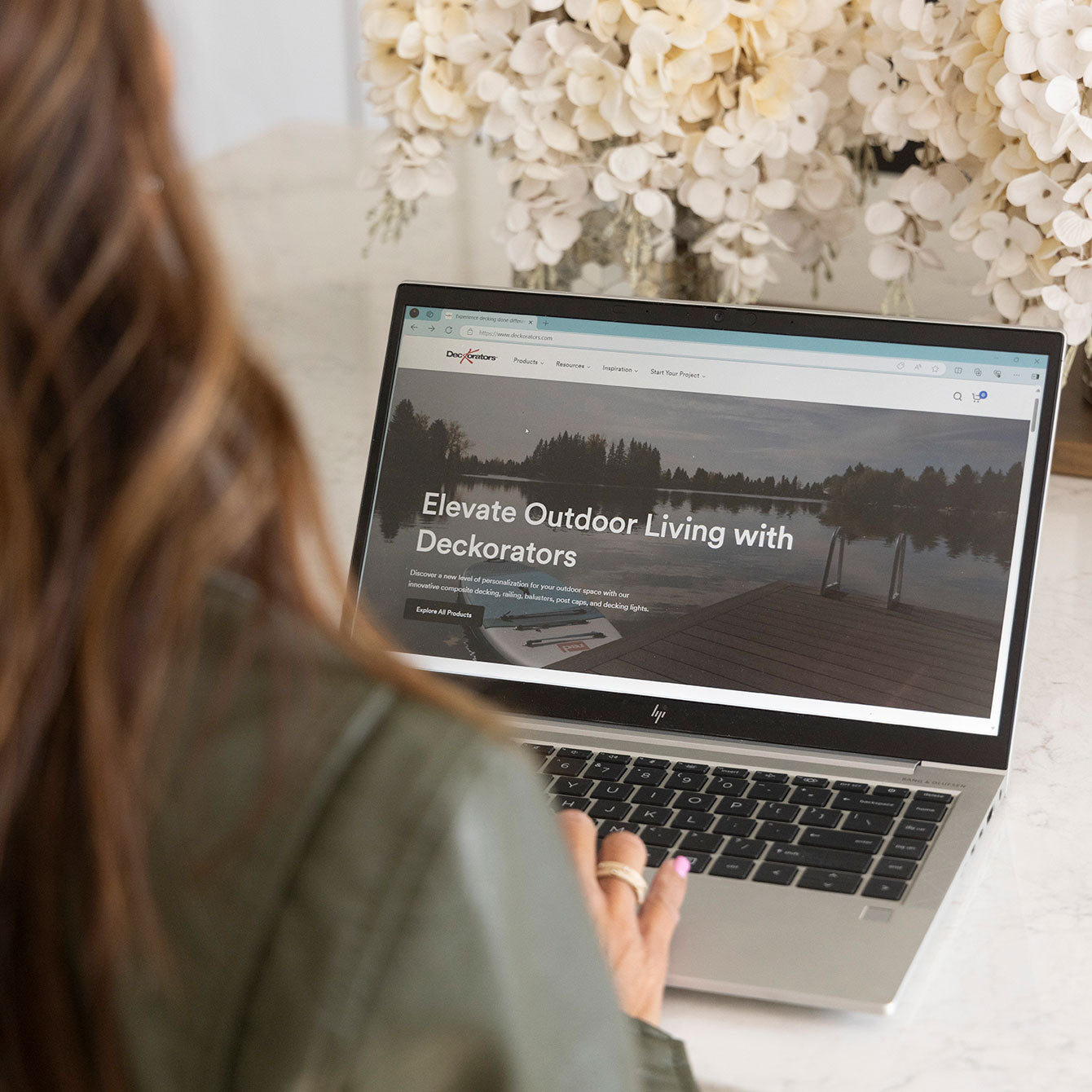 Woman Looking at Deckorators Website on Laptop