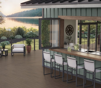 Outdoor deck space featuring Vista Decking in Ironwood with Contemporary Cable Rail in Textured Black with an outdoor kitchen and built-in bar near the water