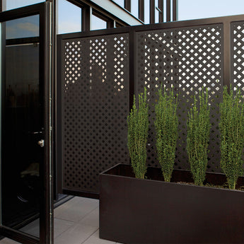 Privacy Wall Built on Modern Outdoor Space with Deckorators Privacy Plastic Lattice in Dark Brown #color_dark-brown