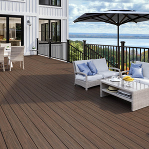 Deck with Lake in the Background Made of Tropics Composite Decking in Hana Brown and Contemporary Rail in Black #color_matte-black